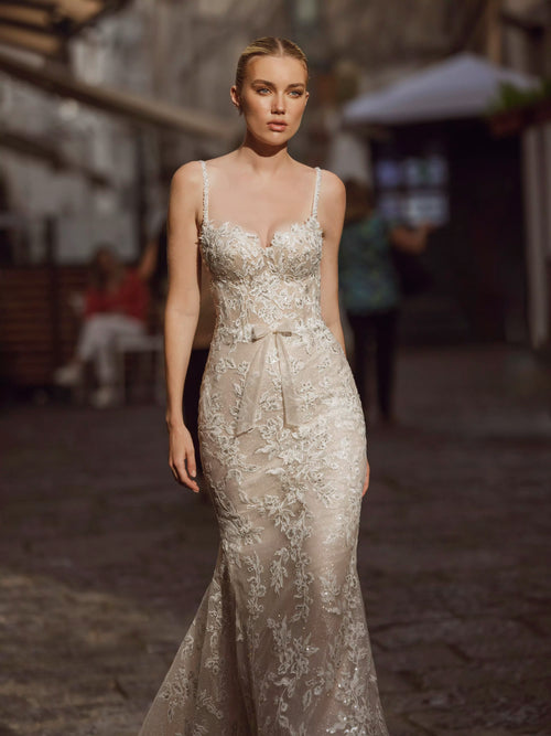 Lace mermaid wedding dress with sweetheart neckline and handcrafted bow by Ricca Sposa, shimmering bridal gown