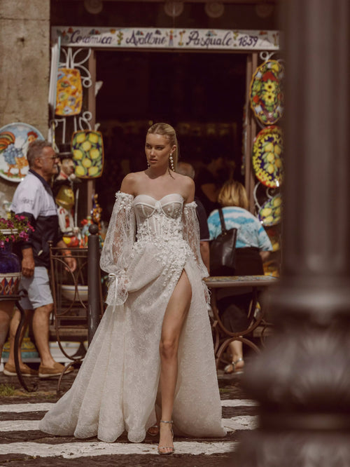 Corset bodice Ricca Sposa Maia wedding dress with 3D floral lace, high slit, and puff sleeves, bespoke bridal gown