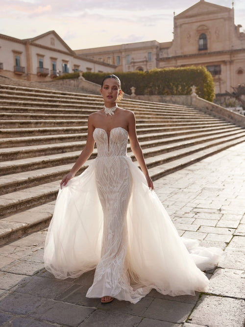 Bespoke strapless mermaid Ricca Sposa gown with geometric lace, plunging V-neck and detachable overskirt bridal gown