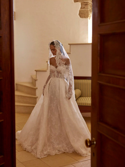 Lace A-line wedding dress with sheer corset bodice, long sleeves and lace veil, handcrafted Ricca Sposa bridal gown