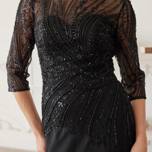 Intricate beaded black Mother of the Bride dress with illusion neckline and 3/4 sleeves, handcrafted wedding gown