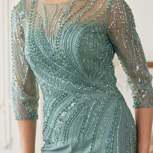 Sequined sage green sheath with illusion neckline and sheer 3/4 sleeves, a bespoke mother of the bride wedding gown