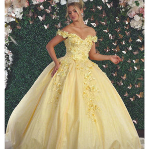 Yellow off-the-shoulder Quinceañera ball gown with 3D floral appliqués and shimmer, handcrafted bespoke bridal gown