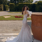 Bespoke shimmering mermaid wedding dress with a sheer corset and ruffled puff sleeves, handcrafted bridal gown