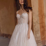 Sheer corset Ricca Sposa Anetta gown with 3D florals and geometric glitter, handcrafted bespoke wedding dress
