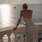 Mermaid floral lace gown with corset back and sheer off-the-shoulder sleeves, bespoke Ricca Sposa Noemi bridal gown