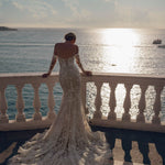 Lace mermaid wedding dress with off-the-shoulder long sleeves and corset back, a handcrafted Ricca Sposa bridal gown