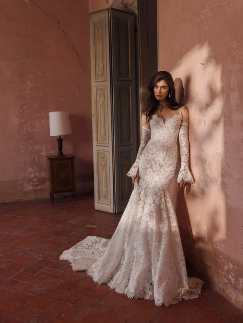Lace trumpet wedding dress with sweetheart neckline and flared sleeves, a bespoke Ricca Sposa bridal gown