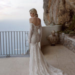 Lace mermaid wedding dress with off-the-shoulder long sleeves and handcrafted details, bespoke Ricca Sposa bridal gown