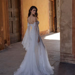 Shimmering lace off-the-shoulder mermaid wedding dress with flared sleeves, bespoke Ricca Sposa Cristina bridal gown