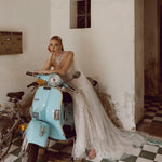 Shimmering sheath wedding dress with a high illusion beaded neckline and tulle train, handcrafted bridal gown