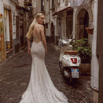 Shimmering beaded mermaid wedding gown with a sheer corset back, bespoke Ricca Sposa Elisanne bridal gown