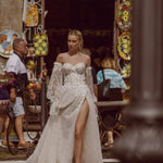 Corset bodice Ricca Sposa Maia wedding dress with 3D floral lace, high slit, and puff sleeves, bespoke bridal gown