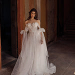 Bespoke A-line tulle wedding dress with 3D floral off-the-shoulder bodice and bow sleeves, handcrafted bridal gown