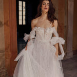 A-line floral Ricca Sposa Arianna wedding dress with sweetheart neckline and tulle bow sleeves, handcrafted bridal gown