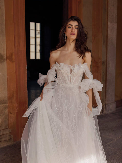 A-line floral Ricca Sposa Arianna wedding dress with sweetheart neckline and tulle bow sleeves, handcrafted bridal gown