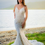 Geometric beaded mermaid wedding dress with a deep plunging neckline and straps, bespoke handcrafted bridal gown