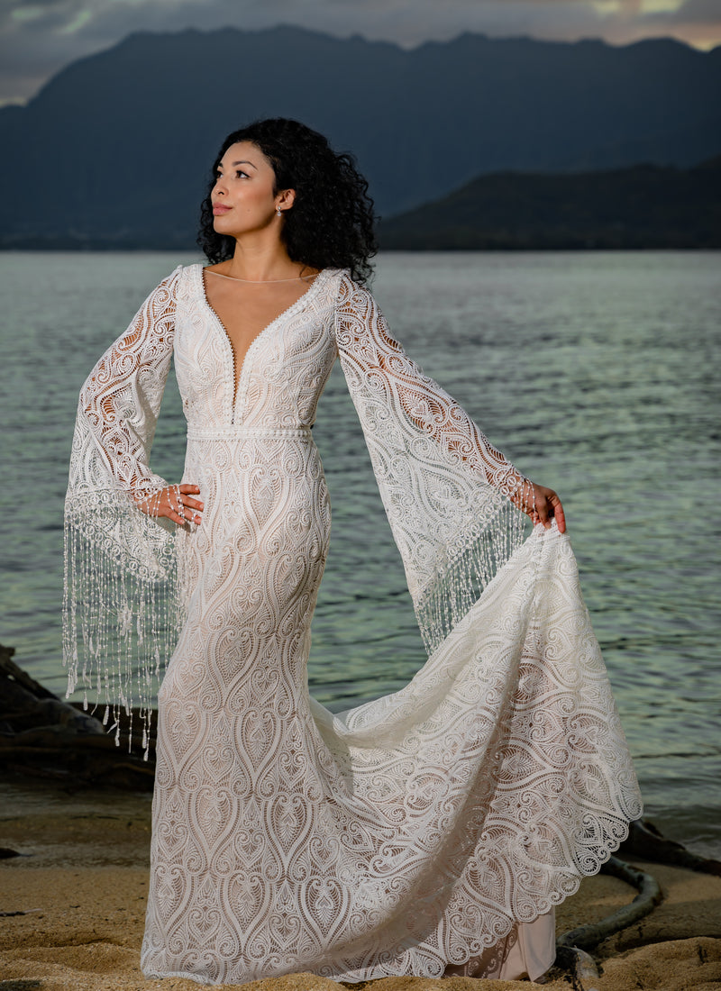 Bespoke boho mermaid lace wedding dress with deep plunging neckline and fringe bell sleeves, handcrafted bridal gown