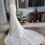 Lace mermaid wedding dress with long sleeves, plunging neckline and dramatic train, bespoke bridal gown