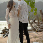 Bespoke lace mermaid wedding dress with long sleeves and deep plunging neckline, handcrafted bridal gown