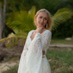 Boho mermaid lace wedding dress with long bell sleeves and scalloped V-neckline, a handcrafted bridal gown