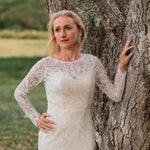 Long sleeve lace mermaid wedding dress with boat neck and bespoke floral accents, handcrafted bridal gown