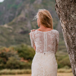 Long sleeve lace mermaid wedding dress with sheer button back and boat neck, handcrafted bridal gown