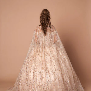 Bespoke champagne glitter Quinceanera ball gown with matching cape and full skirt, handcrafted wedding gown