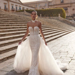 Bespoke strapless mermaid Ricca Sposa gown with geometric lace, plunging V-neck and detachable overskirt bridal gown