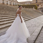 Bespoke ball gown with lace corset bodice and halter neck bow featuring a voluminous tulle skirt bridal gown