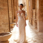 Geometric beaded mermaid wedding gown with plunging strapless neckline and lace choker, handcrafted bridal gown