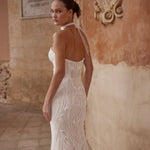 Beaded mermaid wedding dress with a sheer halter neck bow and low back, handcrafted Ricca Sposa bridal gown