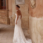 Fitted Ricca Sposa wedding dress with intricate geometric lace, a halter neck and open back bespoke bridal gown