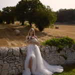 Strapless A-line tulle wedding gown with floral lace appliques and a high leg slit, handcrafted bridal gown