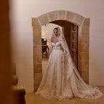 Lace ball gown with corset bodice and long sleeves by Ricca Sposa, a bespoke handcrafted romantic wedding dress