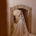 Lace ball gown with sheer corset bodice, long sleeves, and matching lace veil, bespoke Ricca Sposa wedding gown