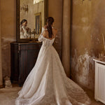 Bespoke off-the-shoulder lace ball gown with long sleeves and scalloped train, handcrafted Ricca Sposa wedding dress