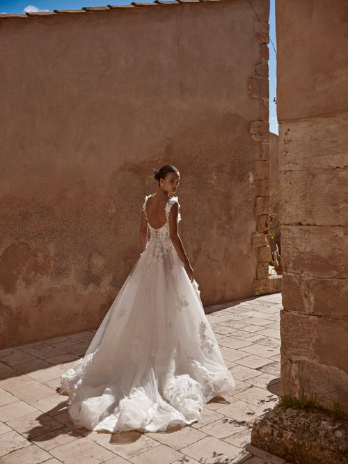 Floral A-line bridal gown with 3D appliqués, low corset back, and long tulle train bespoke wedding dress