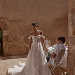 Off-the-shoulder A-line wedding gown with 3D floral lace and sheer bodice, a bespoke Ricca Sposa 04 bridal gown