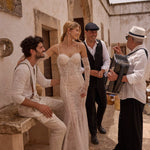 Lace mermaid Ricca Sposa wedding gown with pearl-draped corset and lace sleeves, handcrafted bridal gown