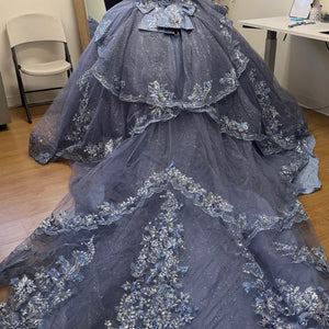 Bespoke blue tiered ball gown with floral lace and long glitter train, handcrafted Quinceañera wedding gown