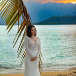 Bespoke lace mermaid wedding dress with long sleeves and a plunging neckline, handcrafted bridal gown