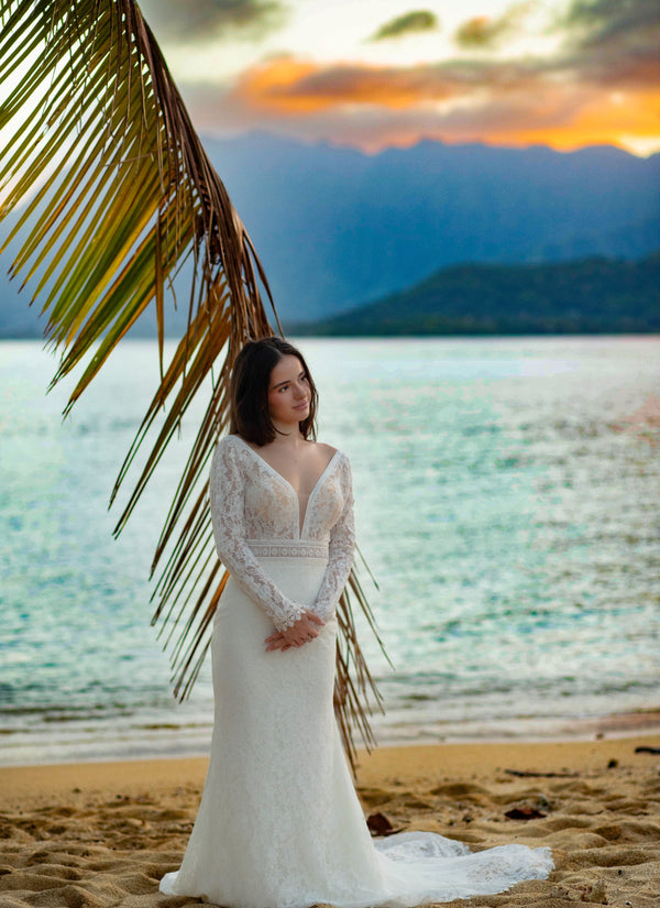 Bespoke lace mermaid wedding dress with long sleeves and a plunging neckline, handcrafted bridal gown