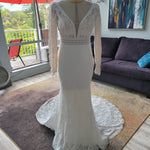 Lace mermaid wedding dress with long sleeves and deep plunging neckline, handcrafted bespoke bridal gown