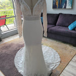 Lace mermaid wedding dress with long sleeves and a deep plunging neckline, bespoke handcrafted bridal gown