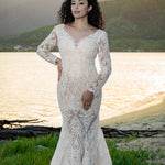 Bespoke long sleeve beaded lace mermaid wedding dress with a deep V-neck, handcrafted bridal gown