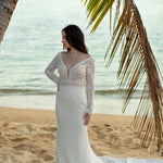Lace mermaid wedding dress with long sleeves and deep plunging neckline, a handcrafted bridal gown