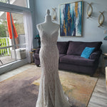 Beaded mermaid wedding dress with a deep plunging neckline and thin straps, bespoke handcrafted bridal gown