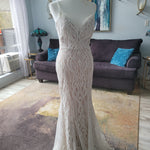 Bespoke beaded mermaid wedding dress with deep plunging neckline and straps, handcrafted geometric bridal gown