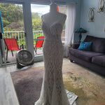 Beaded mermaid wedding dress with deep plunging neckline and straps, bespoke handcrafted geometric bridal gown